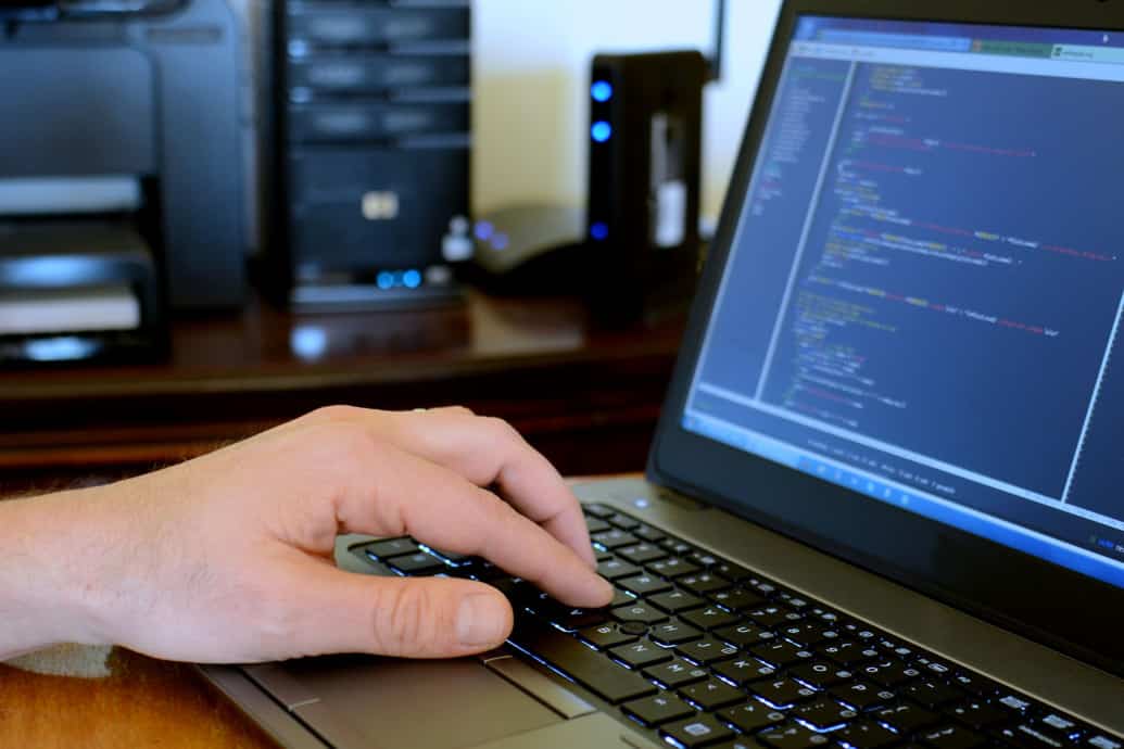 programmer working a laptop computer needing managed it services