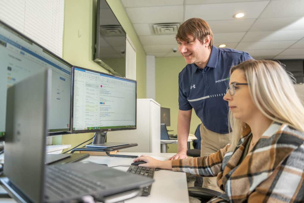 Two employees of IntermixIT collaborating on delivering managed IT services to businesses.