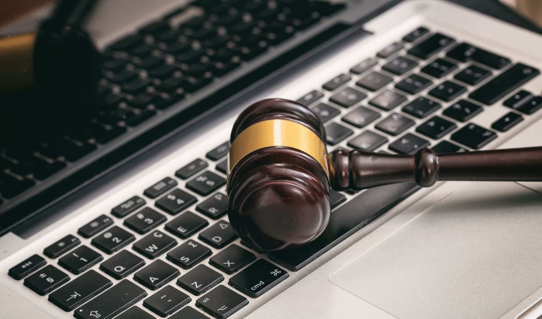 Judge's gavel placed on a laptop symbolizing secure IT solutions for law firms.