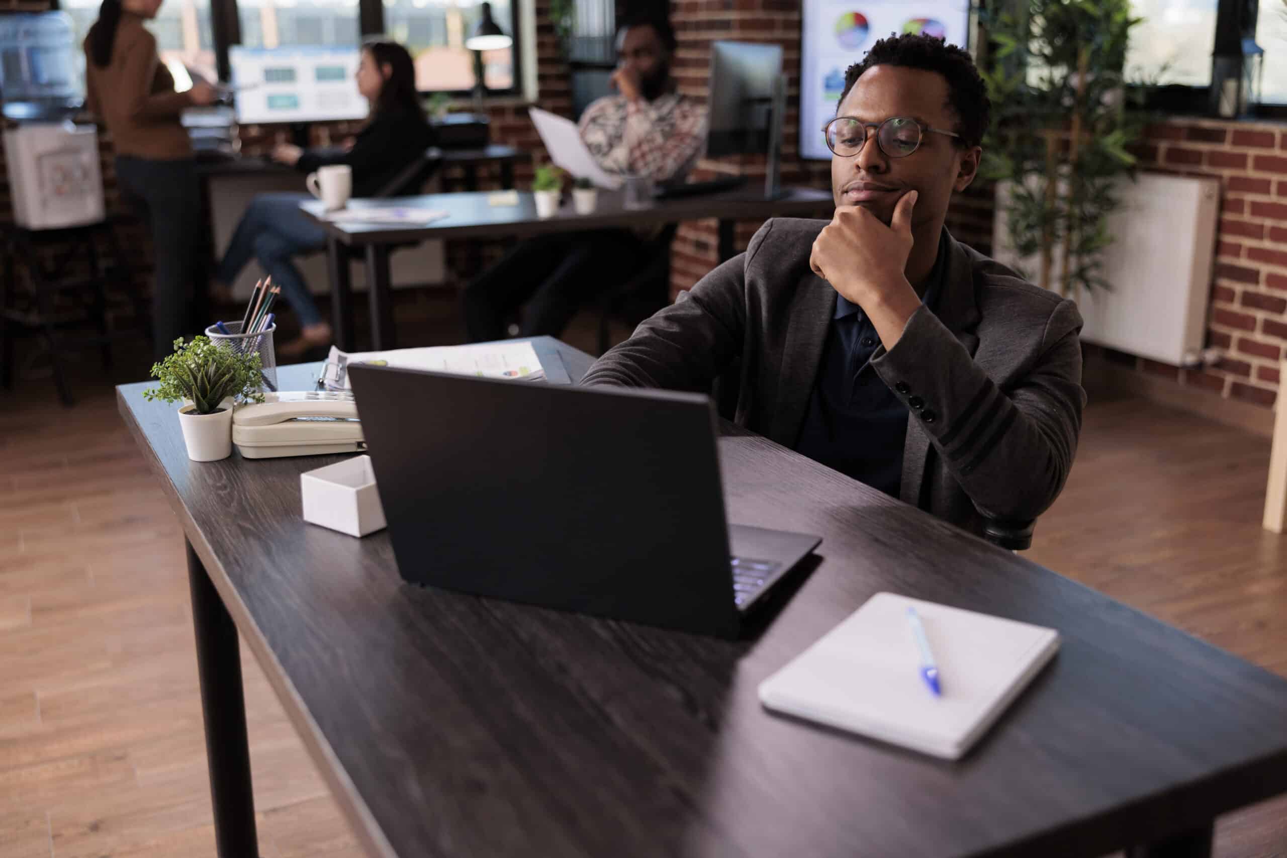 business man working at desk with a laptop.